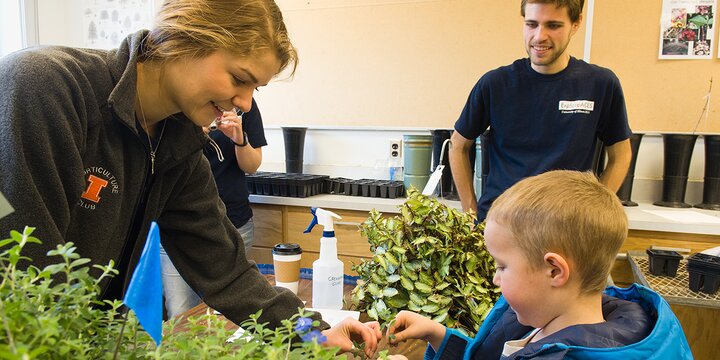 Derrick Hopkins of Farmersville gets some help with a plant cutting from Horitculture president Ryanne Ardisana during ExplorACES on Saturday morning. 